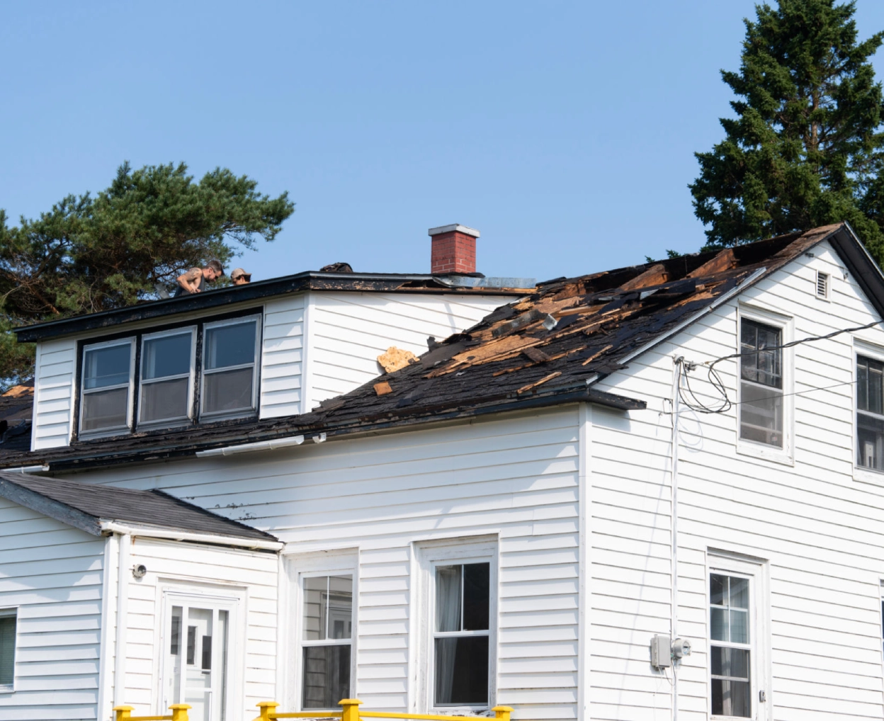 Damaged roof on white house