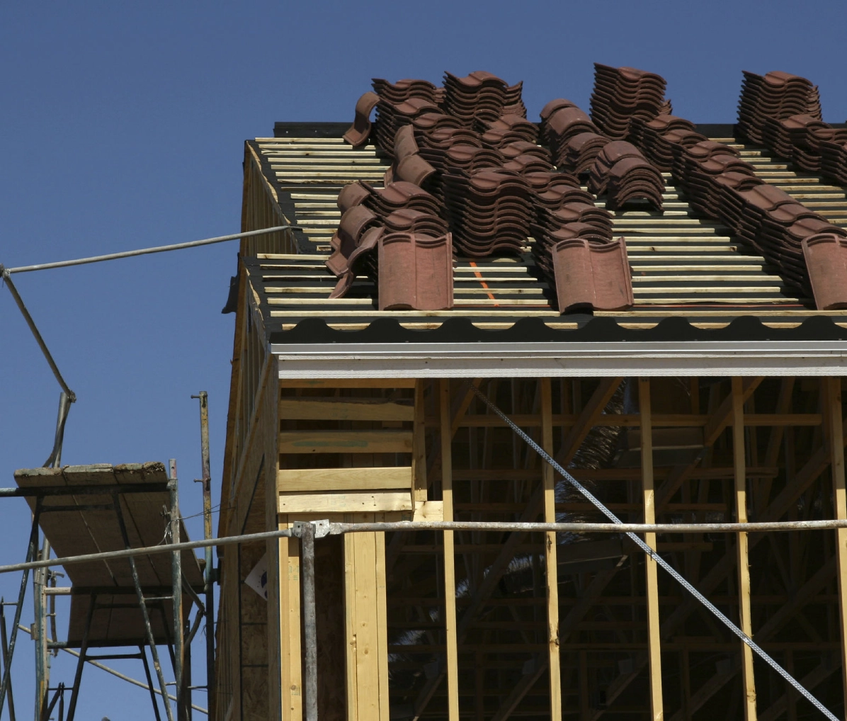 Roof under construction with stacked tiles