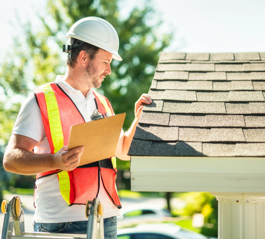 Roofer assessing roof condition