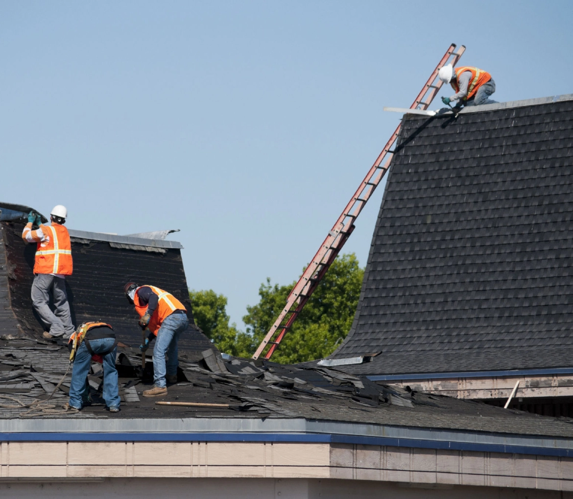 Construction crew fixing building roof